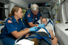 girl being treated by Paramedics in an Ambulance